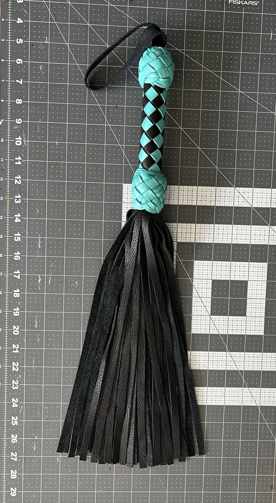 Turquoise and black handle flogger