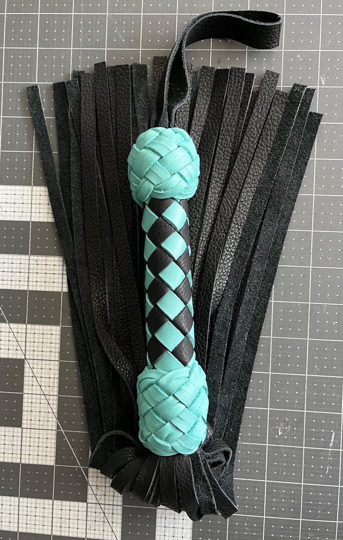 Turquoise and black handle flogger