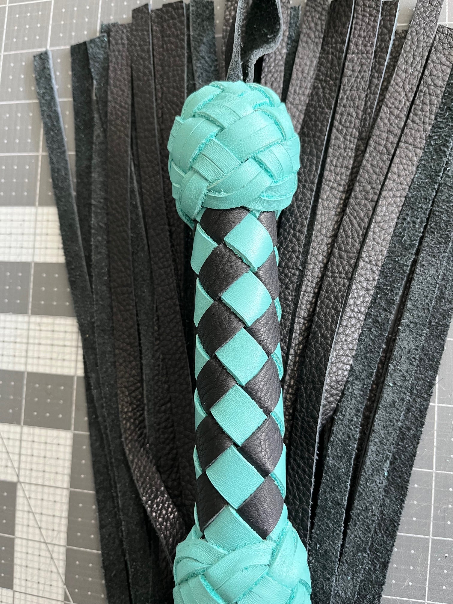 Turquoise and black handle flogger