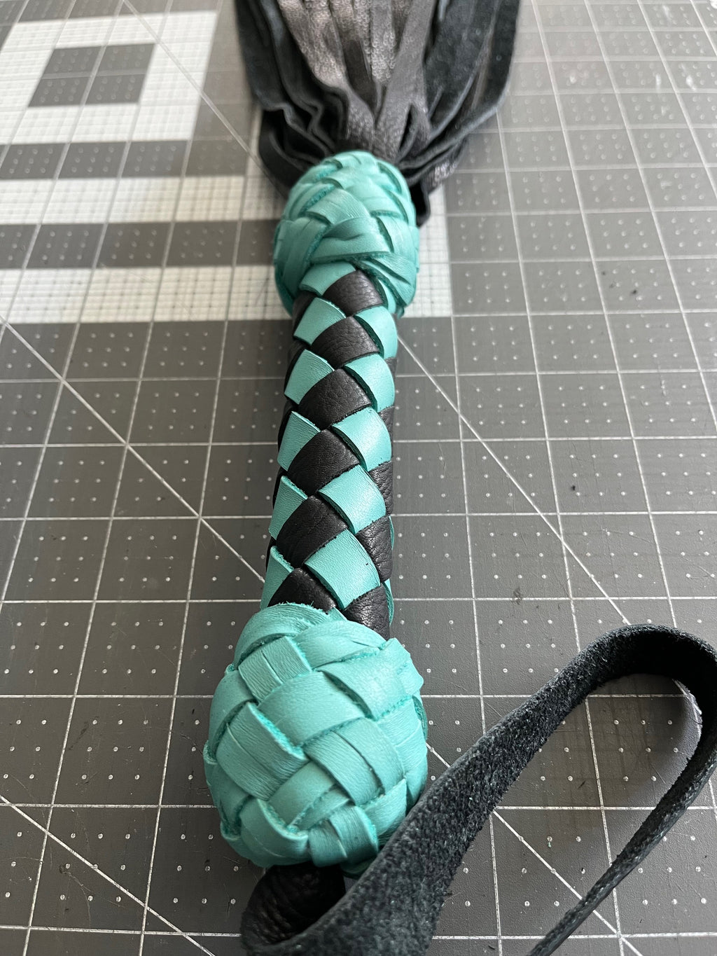 Turquoise and black handle flogger