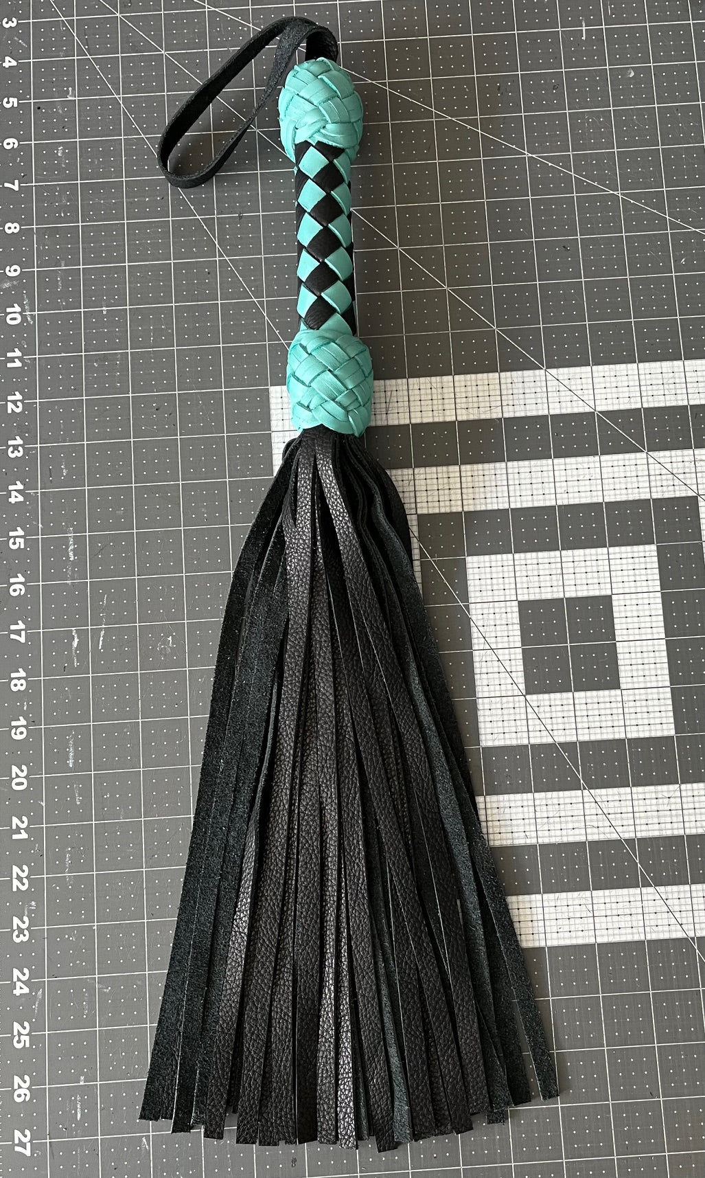 Turquoise and black handle flogger